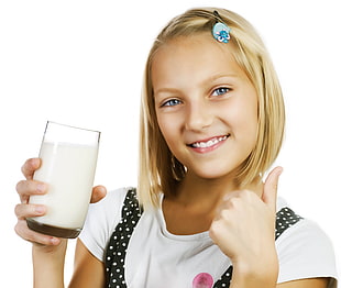 girl holding clear drinking glass